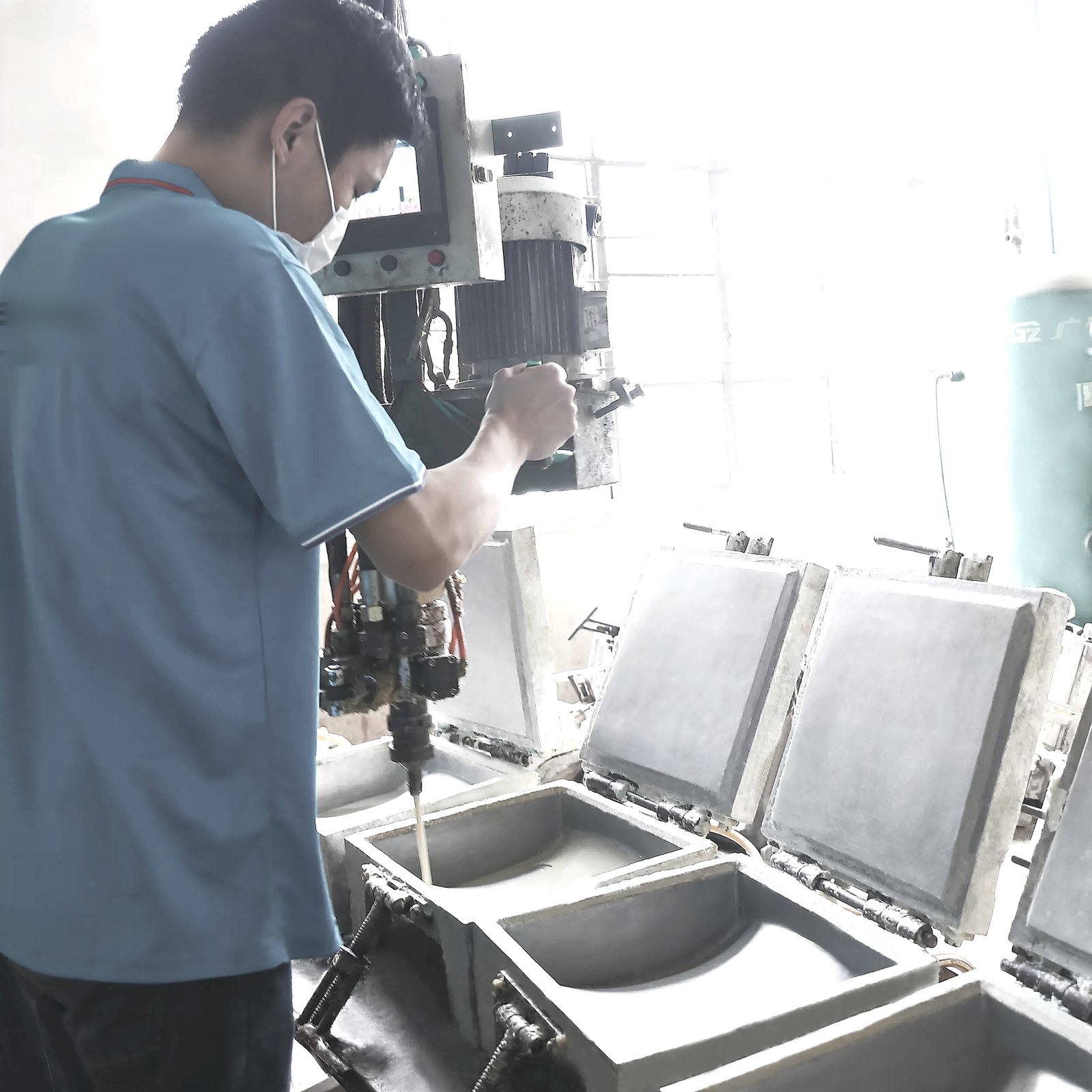 Worker pouring foam into a mould on the DOWCHI pillow production line