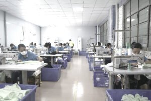 Sewing operators at industrial machines assembling pillow covers